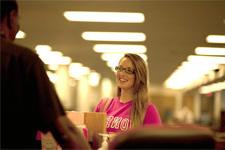 Photo of a support desk person helping a student